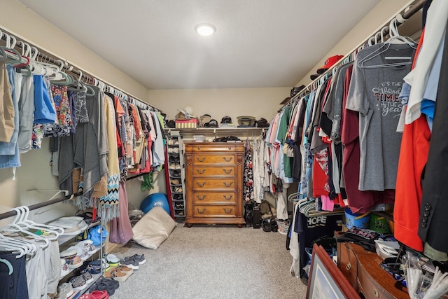 walk in closet with carpet