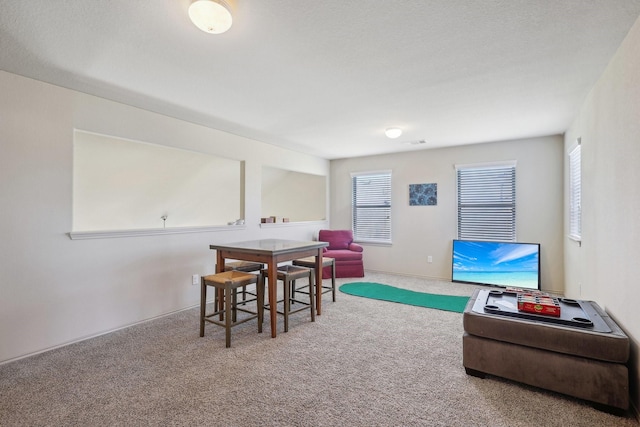 carpeted dining space with visible vents