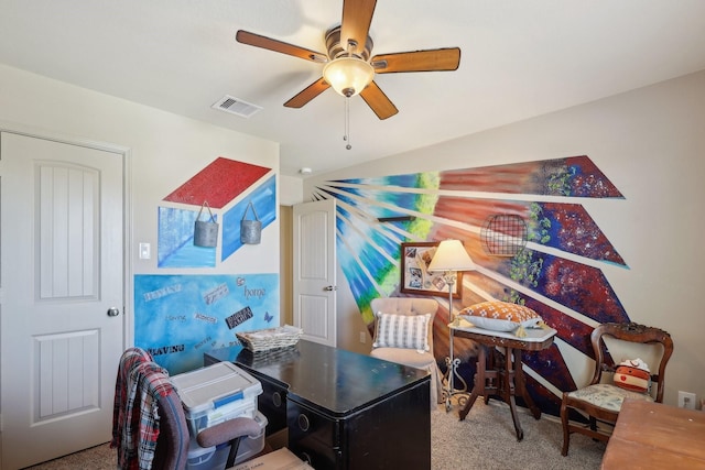 carpeted office featuring visible vents, lofted ceiling, and a ceiling fan