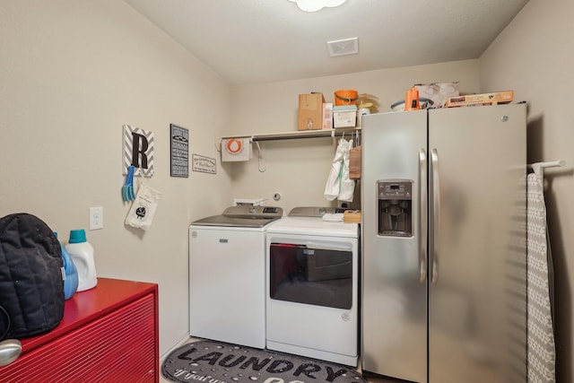 laundry area with washing machine and clothes dryer, laundry area, and visible vents