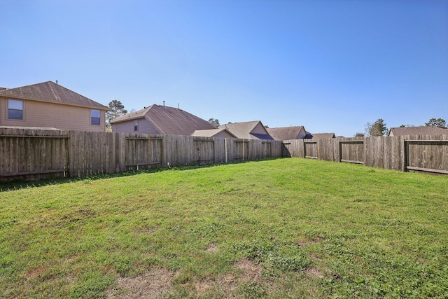 view of yard with a fenced backyard