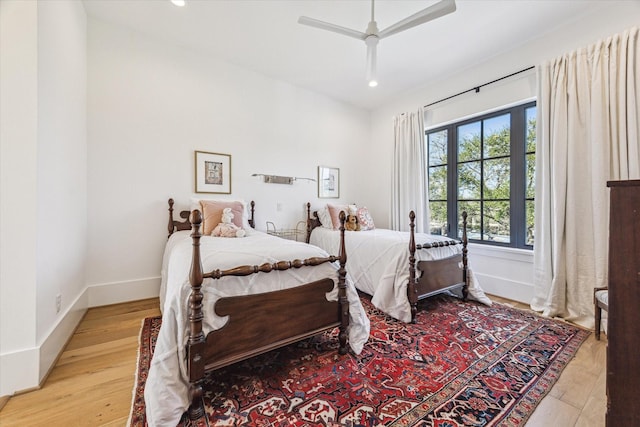 bedroom with a ceiling fan, recessed lighting, wood finished floors, and baseboards