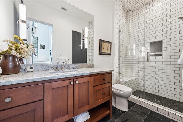 full bathroom featuring vanity, a shower stall, toilet, and visible vents