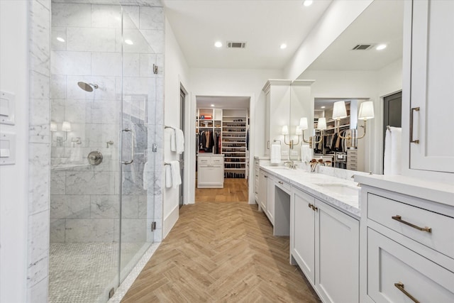 bathroom featuring visible vents, a stall shower, and double vanity