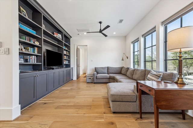 living area featuring light wood-type flooring, visible vents, recessed lighting, and a ceiling fan