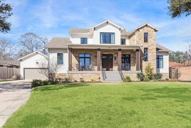 view of front of house with driveway, stone siding, fence, covered porch, and a front yard