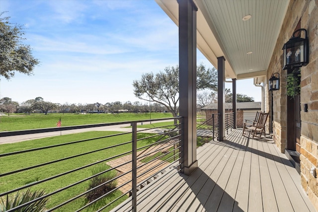 wooden terrace featuring a yard