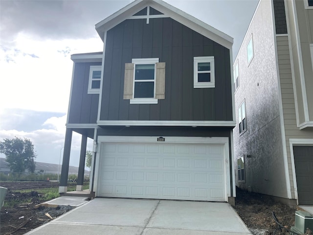 13109 Mundet Dr, Houston, TX 77047 - view of front of property featuring board and batten siding, a garage, and concrete driveway
