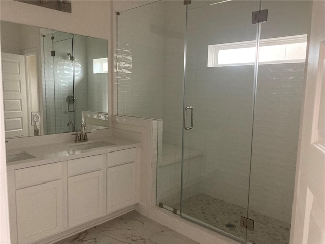 13109 Mundet Dr, Houston, TX 77047 - bathroom featuring a stall shower, marble finish floors, and double vanity