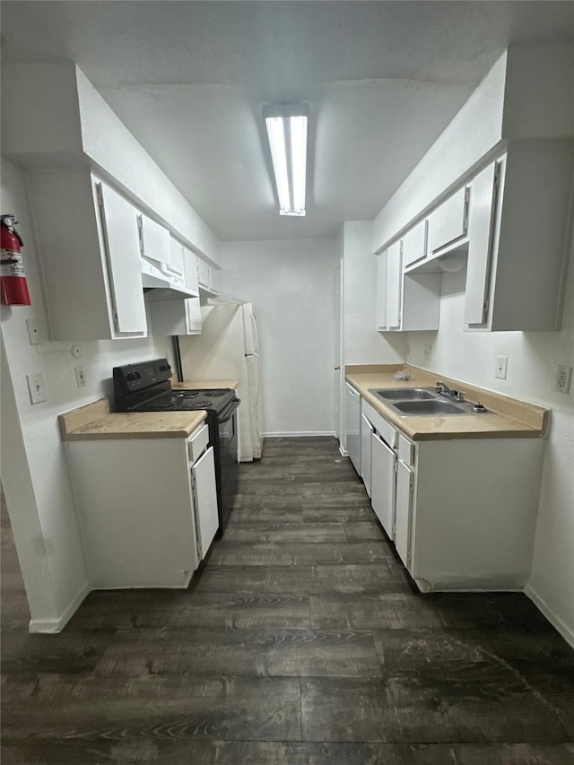 kitchen with white appliances, dark wood-style flooring, a sink, light countertops, and white cabinets