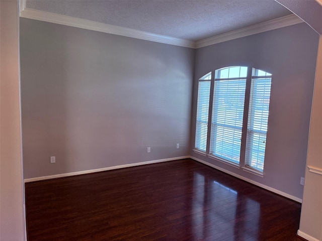 spare room featuring plenty of natural light, crown molding, and dark wood-style flooring