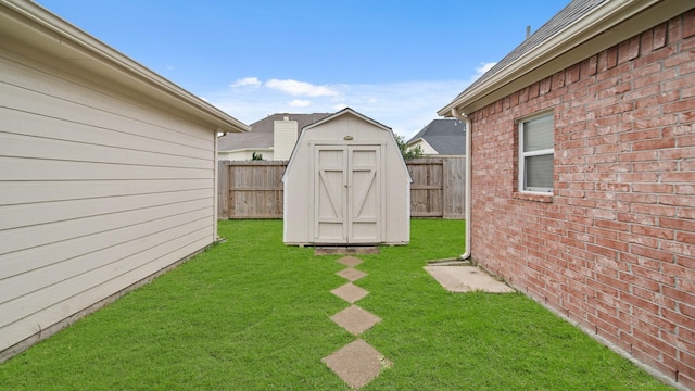 view of yard featuring a storage shed, an outbuilding, and a fenced backyard