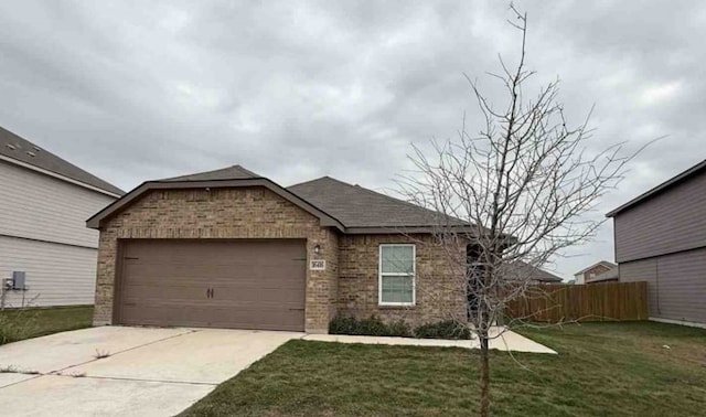 ranch-style house featuring a front yard, fence, concrete driveway, a garage, and brick siding