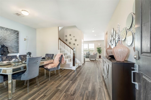 dining area featuring visible vents, stairs, baseboards, and dark wood-style flooring