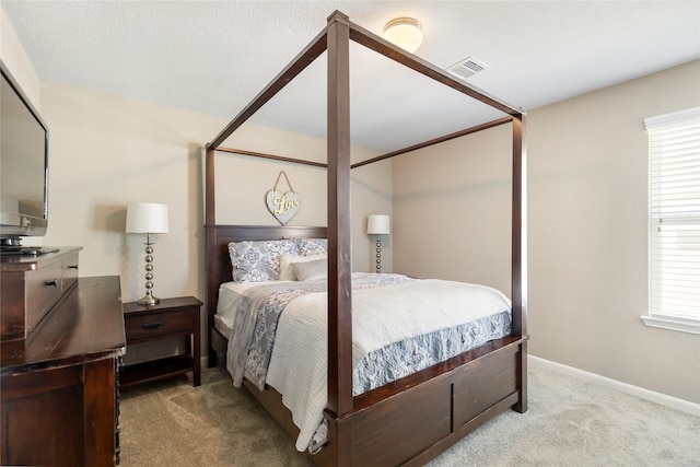 carpeted bedroom featuring visible vents and baseboards