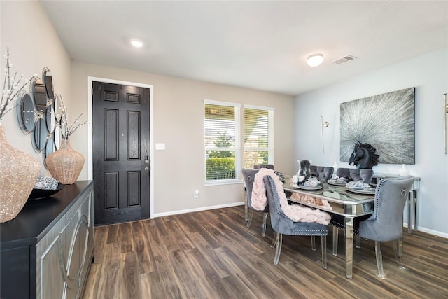 dining room with visible vents, baseboards, and dark wood-style flooring