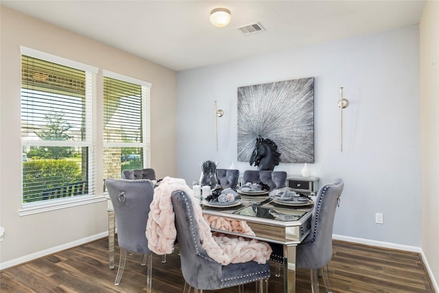 dining room with visible vents, baseboards, and wood finished floors