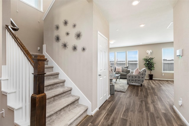 stairs with visible vents, recessed lighting, wood finished floors, and baseboards