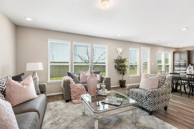 living area featuring recessed lighting, baseboards, and wood finished floors