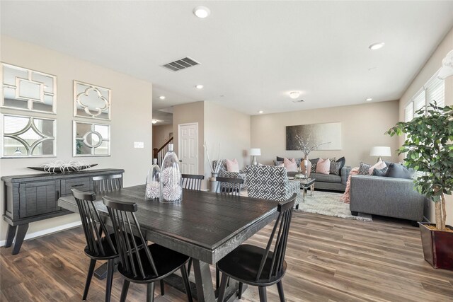 dining space featuring recessed lighting, visible vents, wood finished floors, and stairs