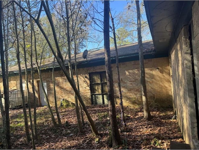 view of side of home featuring brick siding