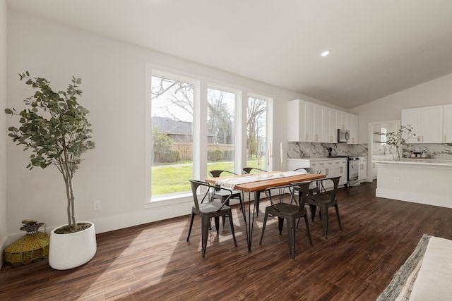 dining area featuring dark wood-type flooring, recessed lighting, baseboards, and vaulted ceiling