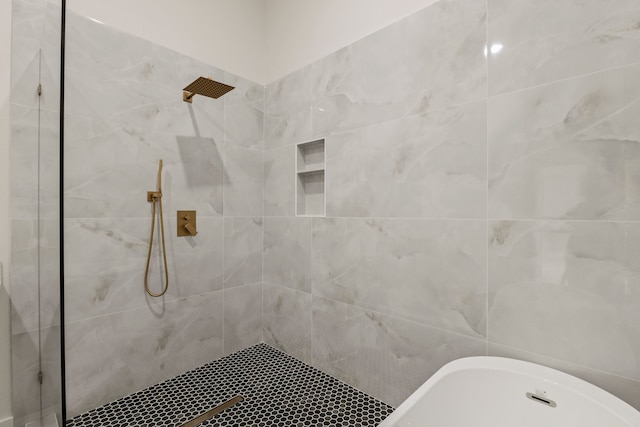 bathroom with a freestanding bath and tiled shower