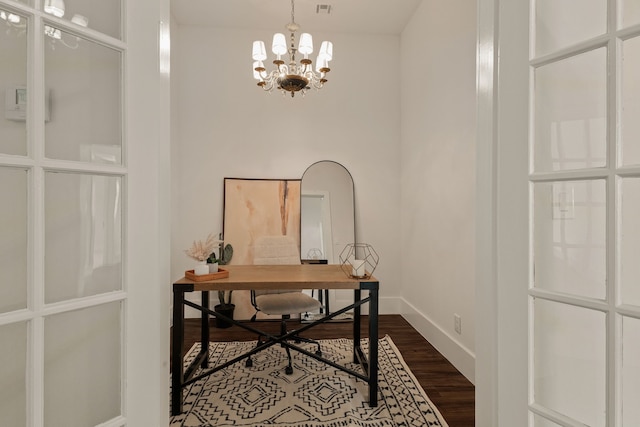 home office featuring dark wood finished floors, an inviting chandelier, and baseboards