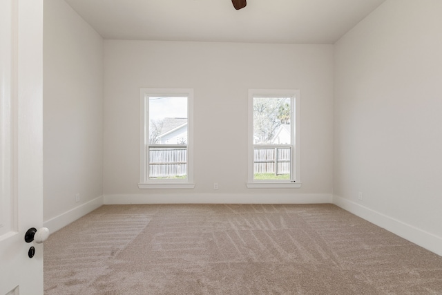 carpeted spare room with baseboards