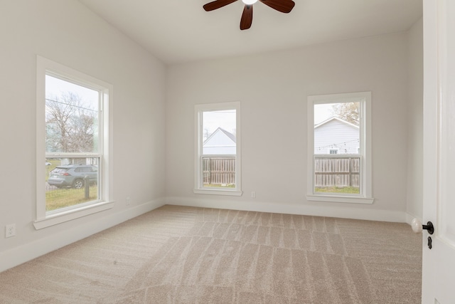 spare room featuring carpet floors and plenty of natural light