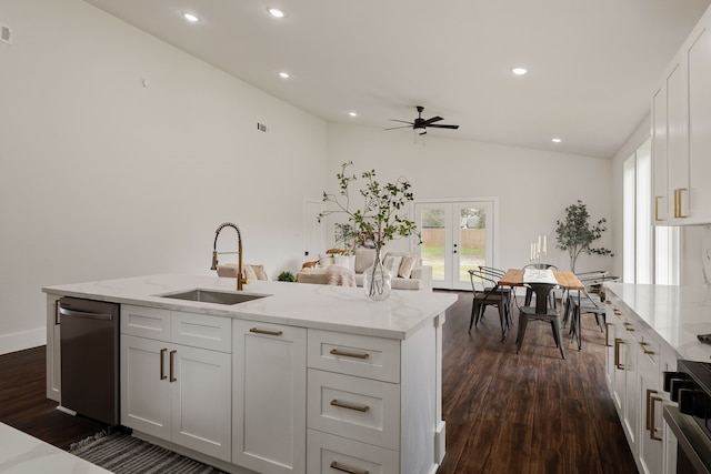 kitchen with dark wood finished floors, french doors, lofted ceiling, and a sink