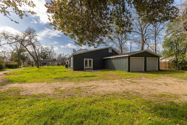 exterior space featuring french doors, a garage, and fence