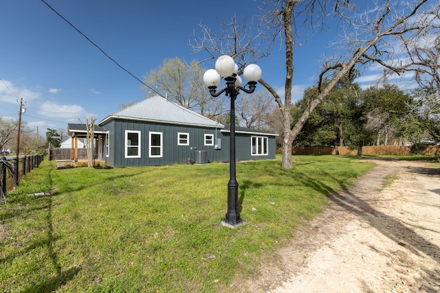 back of house with a yard, central AC, and fence