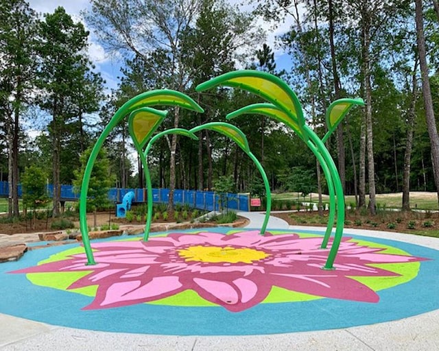 view of jungle gym featuring fence and a sink