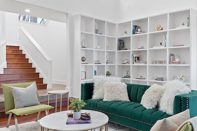 living area featuring stairway and wood finished floors