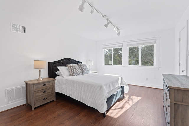 bedroom featuring dark wood finished floors, baseboards, and visible vents