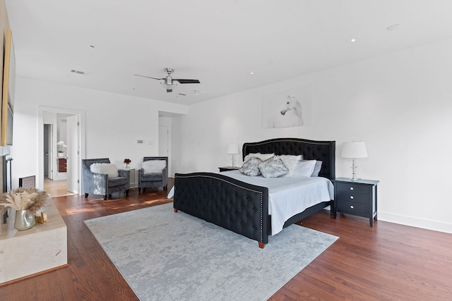 bedroom featuring visible vents, baseboards, dark wood-style floors, and a ceiling fan