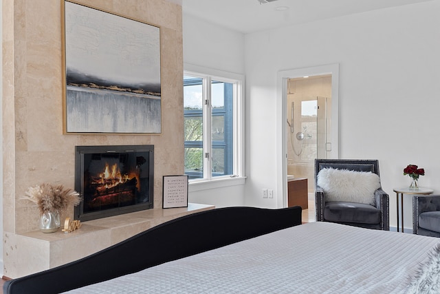 bedroom featuring a fireplace and ensuite bath