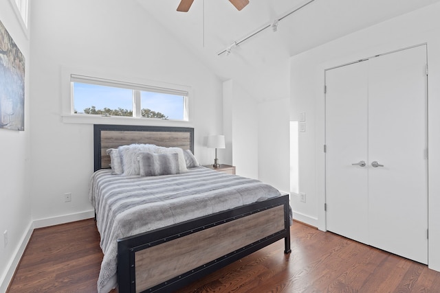 bedroom featuring track lighting, wood finished floors, baseboards, and ceiling fan