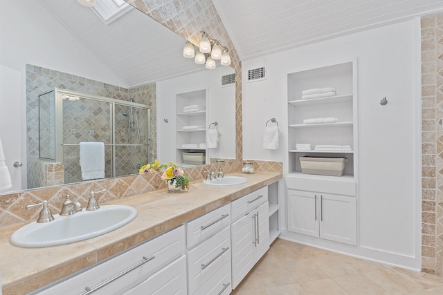 full bathroom featuring a shower stall, double vanity, visible vents, and a sink