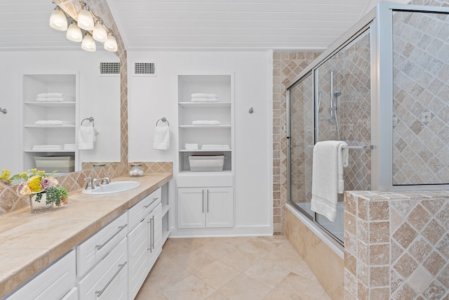 bathroom featuring vanity, built in features, visible vents, and tile patterned flooring