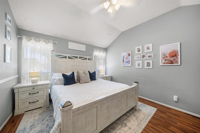 bedroom with a ceiling fan, visible vents, baseboards, dark wood finished floors, and vaulted ceiling