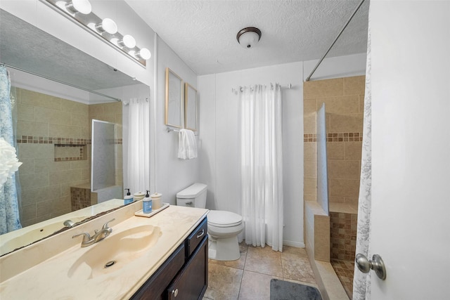 full bathroom featuring tile patterned floors, toilet, a textured ceiling, tiled shower, and vanity