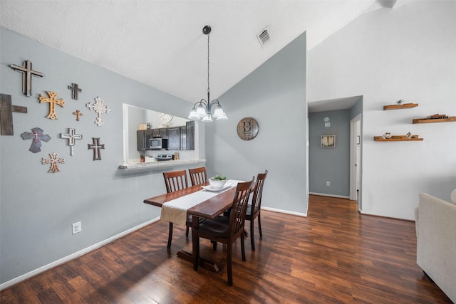 dining area featuring a chandelier, baseboards, lofted ceiling, and wood finished floors