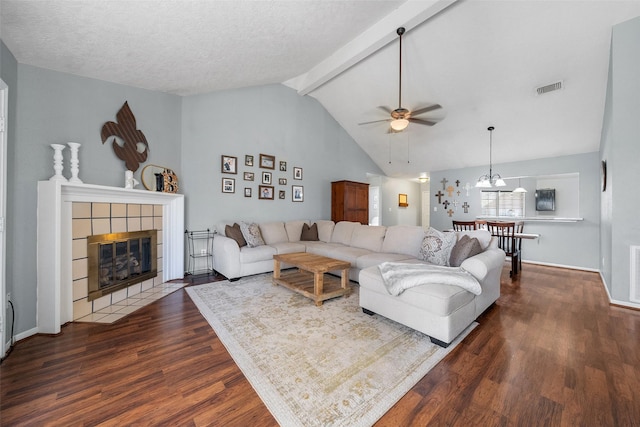 living room featuring visible vents, a fireplace, lofted ceiling with beams, and dark wood-style flooring