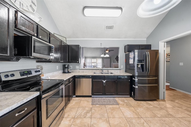 kitchen with visible vents, a sink, appliances with stainless steel finishes, light tile patterned floors, and lofted ceiling