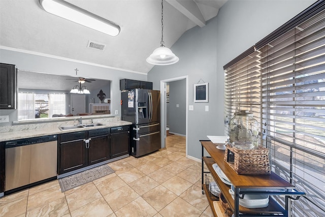 kitchen with visible vents, light stone countertops, vaulted ceiling, appliances with stainless steel finishes, and a sink