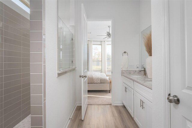 26711 Grandiflora Dr, Magnolia, TX 77355 - ensuite bathroom featuring vanity, wood finished floors, a ceiling fan, and a walk in shower