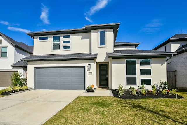 prairie-style home featuring stucco siding, a front yard, concrete driveway, and an attached garage