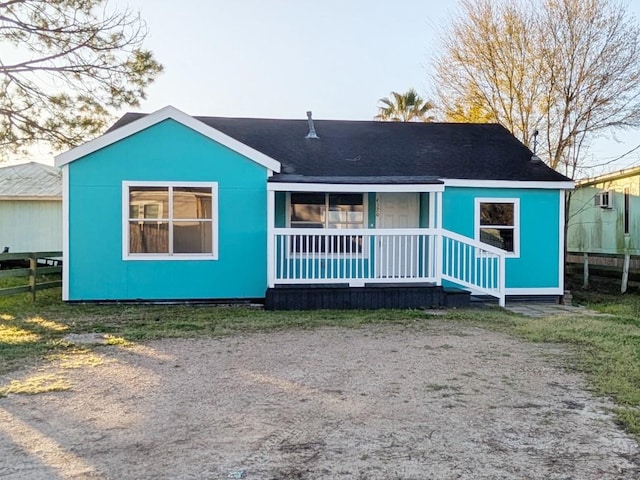 view of front of house featuring covered porch and fence